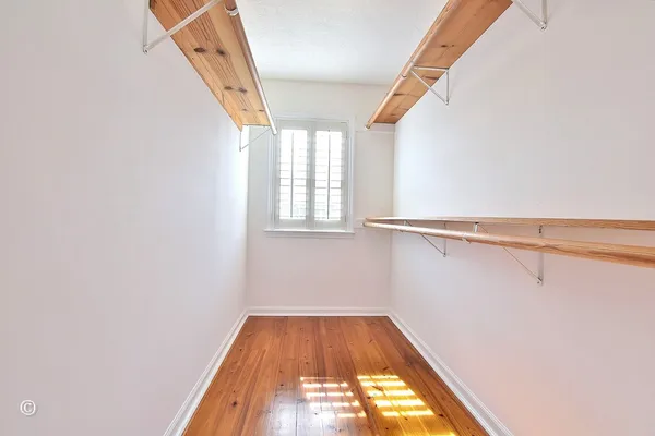 a balcony with wooden floor and fence