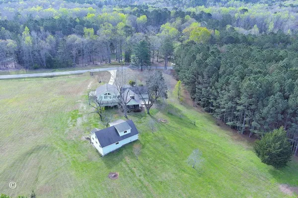 a backyard of a house with lots of green space and trees