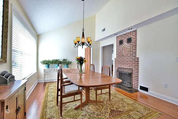 a living room with furniture a wooden floor and a fireplace