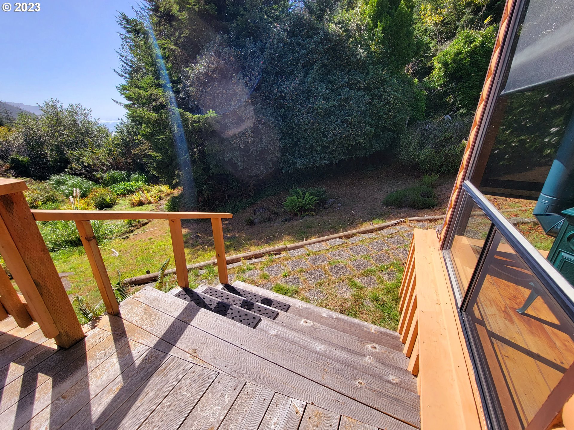 19921 Whaleshead Road, Unit OV8 Brookings, OR 97415 - Photo 13 of 48 a view of a balcony with chairs and wooden floor