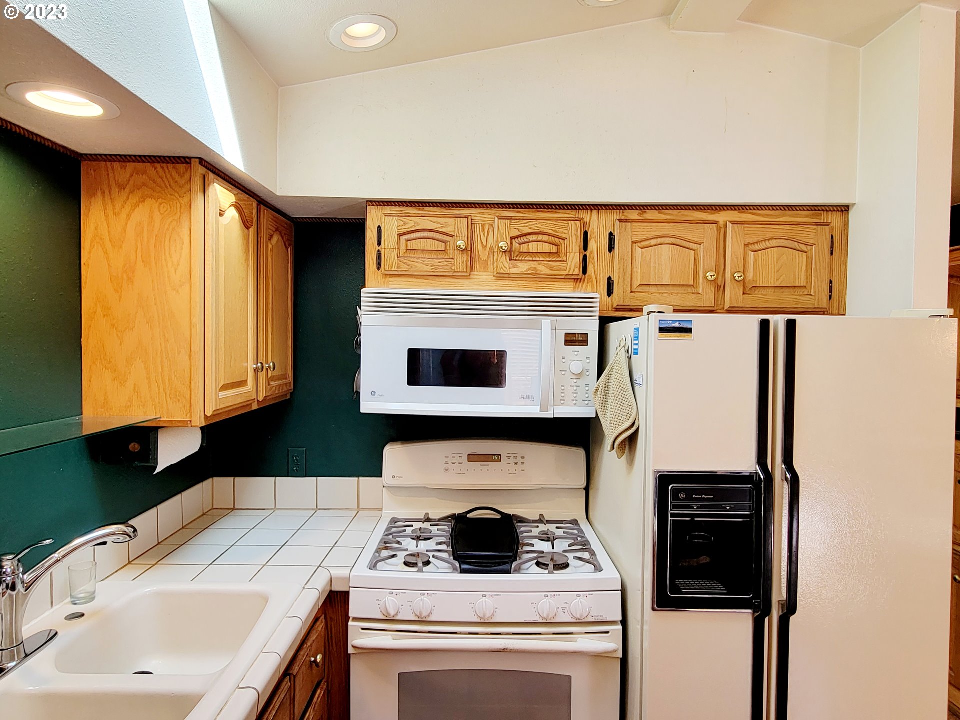 19921 Whaleshead Road, Unit OV8 Brookings, OR 97415 - Photo 27 of 48 a kitchen with stainless steel appliances granite countertop a stove and a microwave