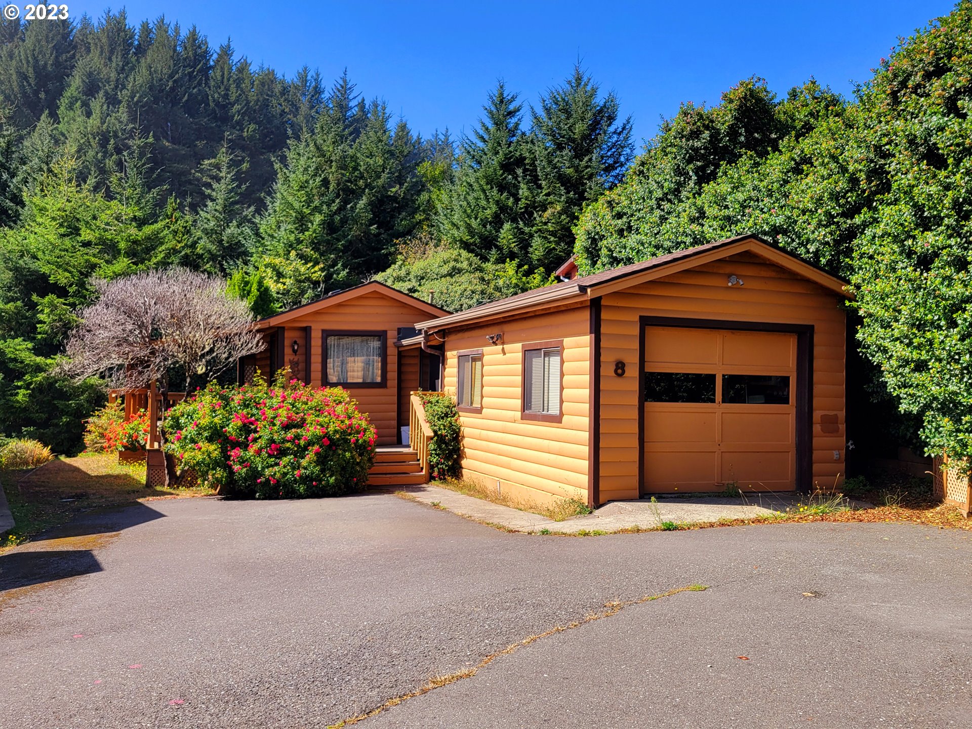 19921 Whaleshead Road, Unit OV8 Brookings, OR 97415 - Photo 3 of 48 a front view of a house with a garden