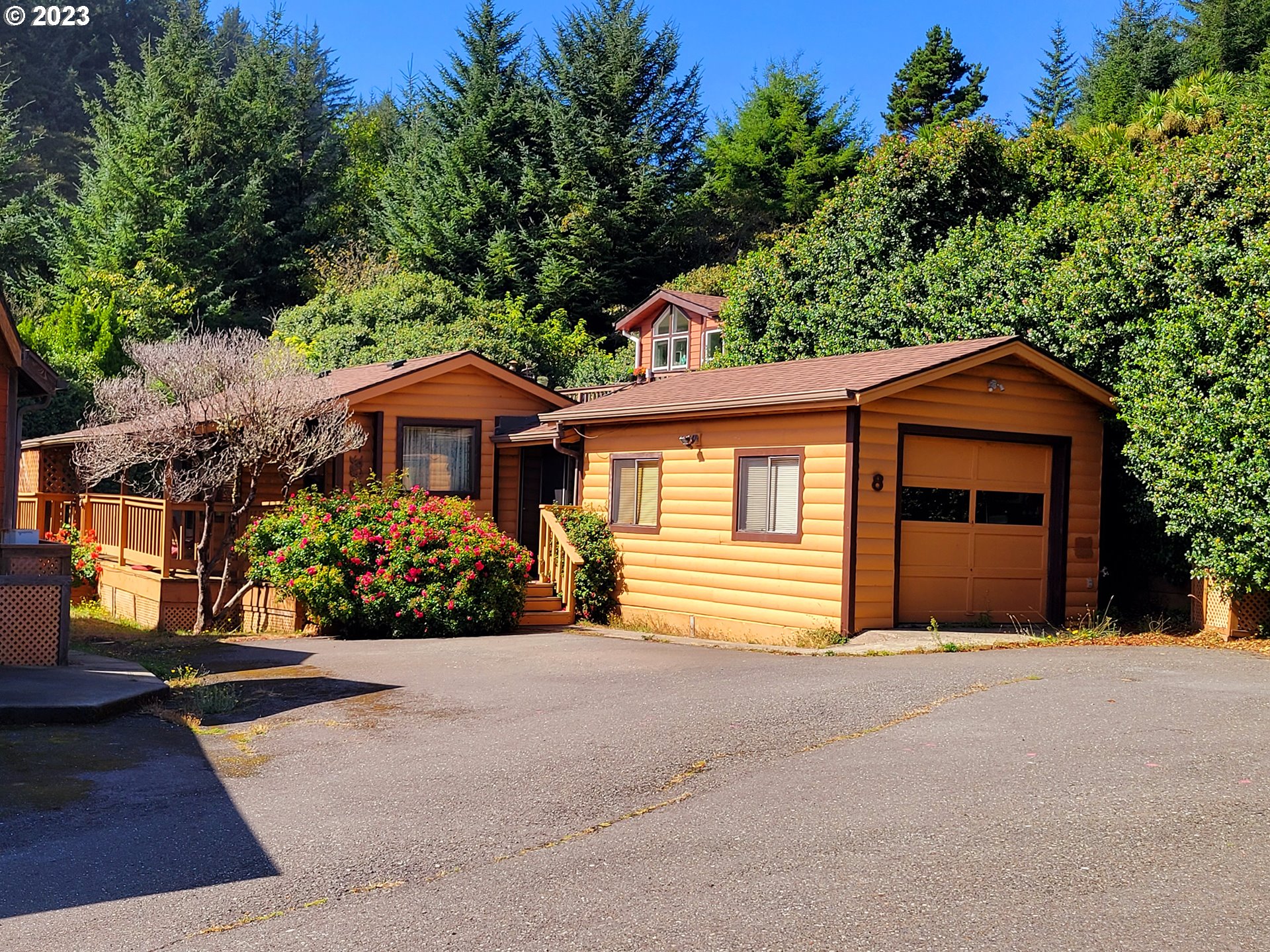 19921 Whaleshead Road, Unit OV8 Brookings, OR 97415 - Photo 31 of 48 a front view of a house with a garden