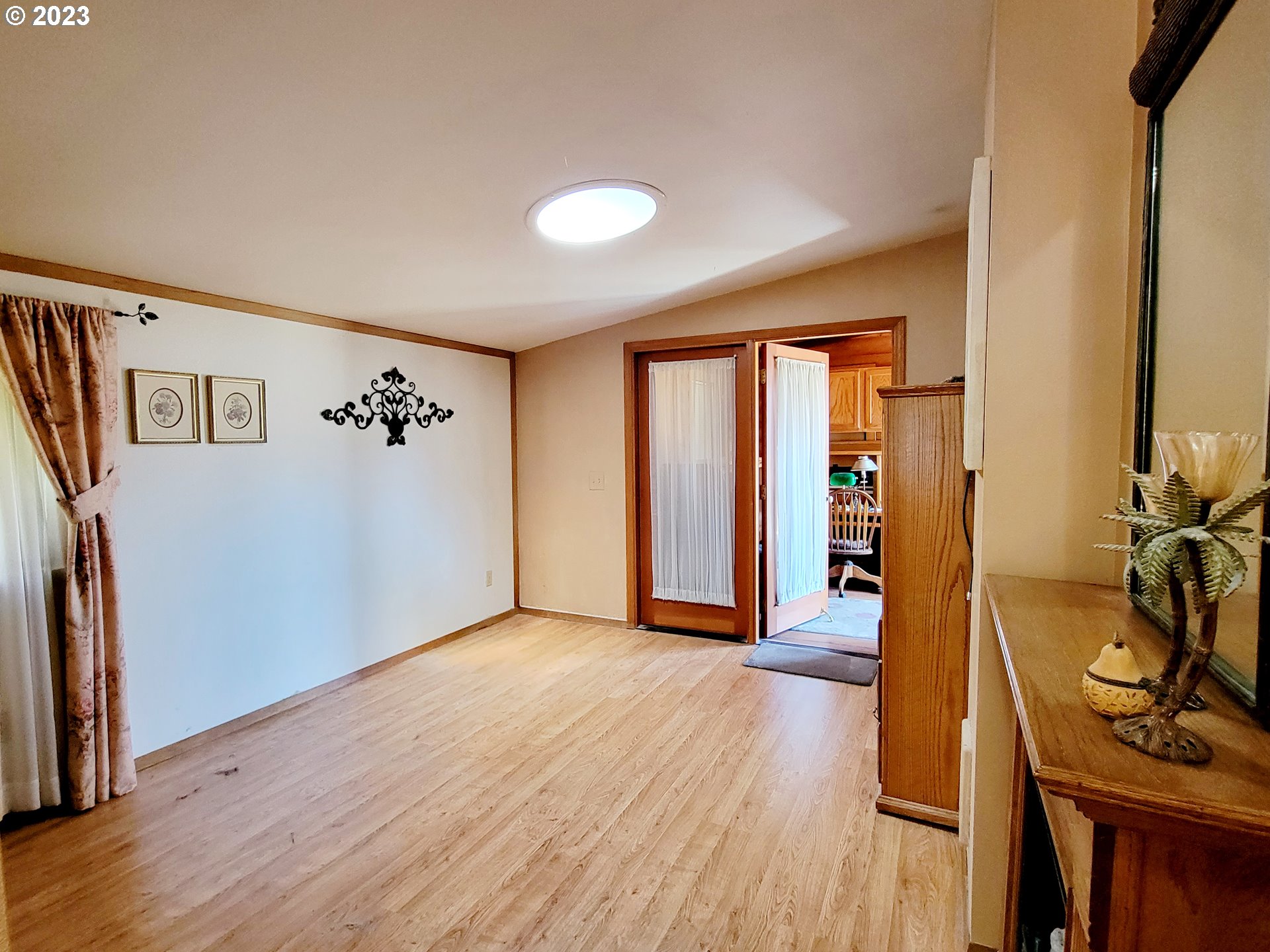 19921 Whaleshead Road, Unit OV8 Brookings, OR 97415 - Photo 38 of 48 a view of an empty room with wooden floor and windows