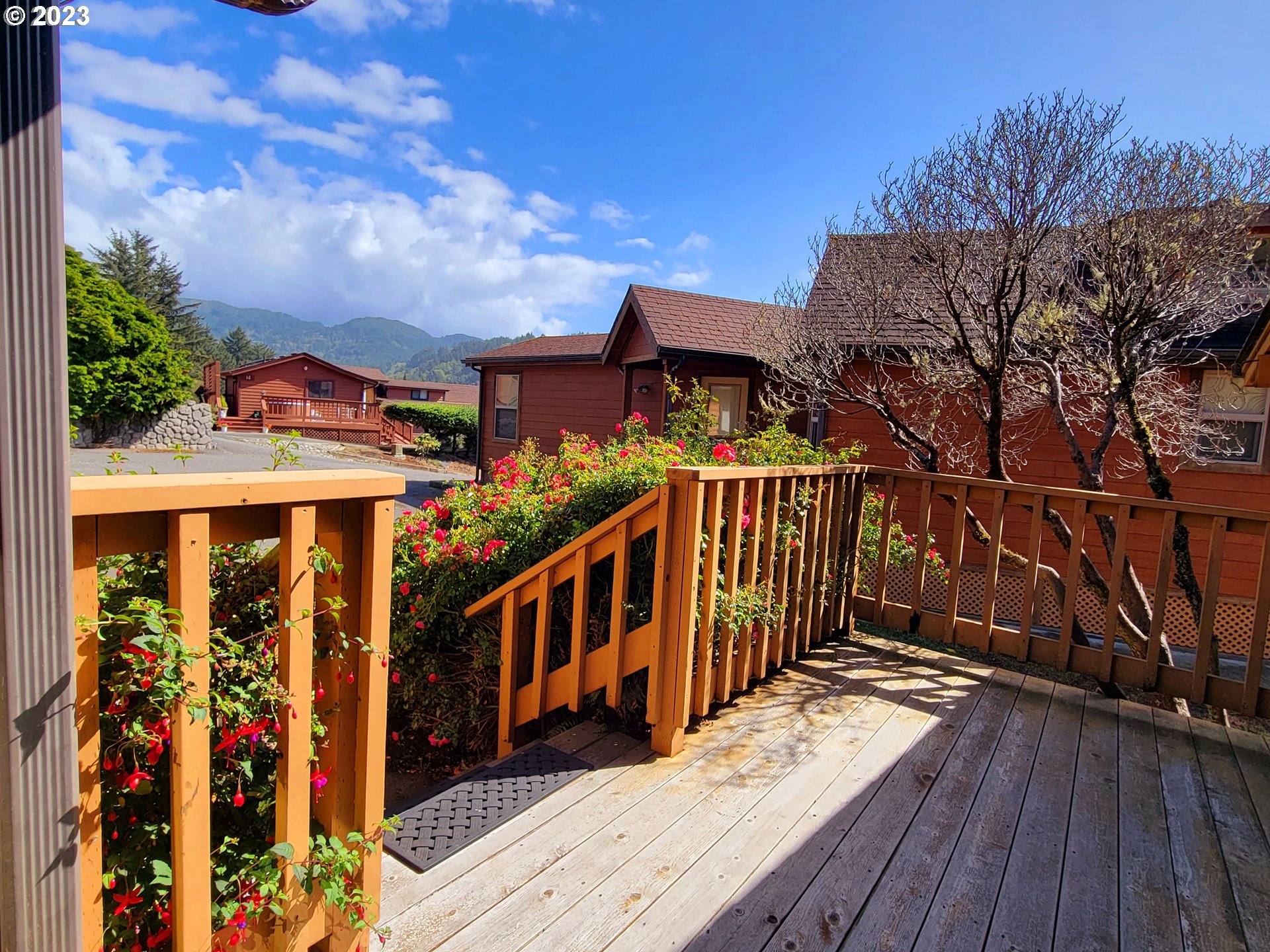 19921 Whaleshead Road, Unit OV8 Brookings, OR 97415 - Photo 42 of 48 a view of a house with wooden deck