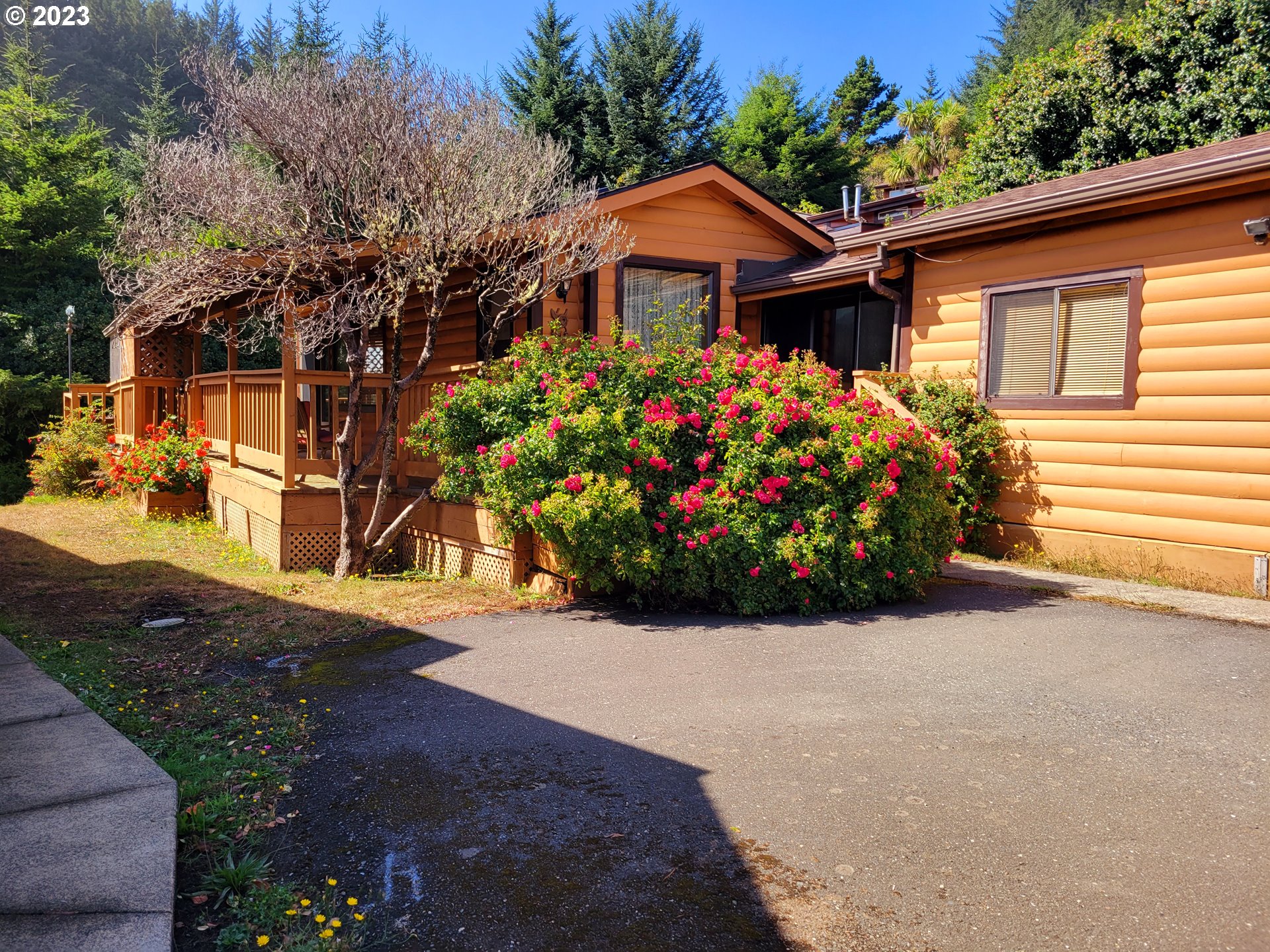 19921 Whaleshead Road, Unit OV8 Brookings, OR 97415 - Photo 46 of 48 a front view of a house with a garden