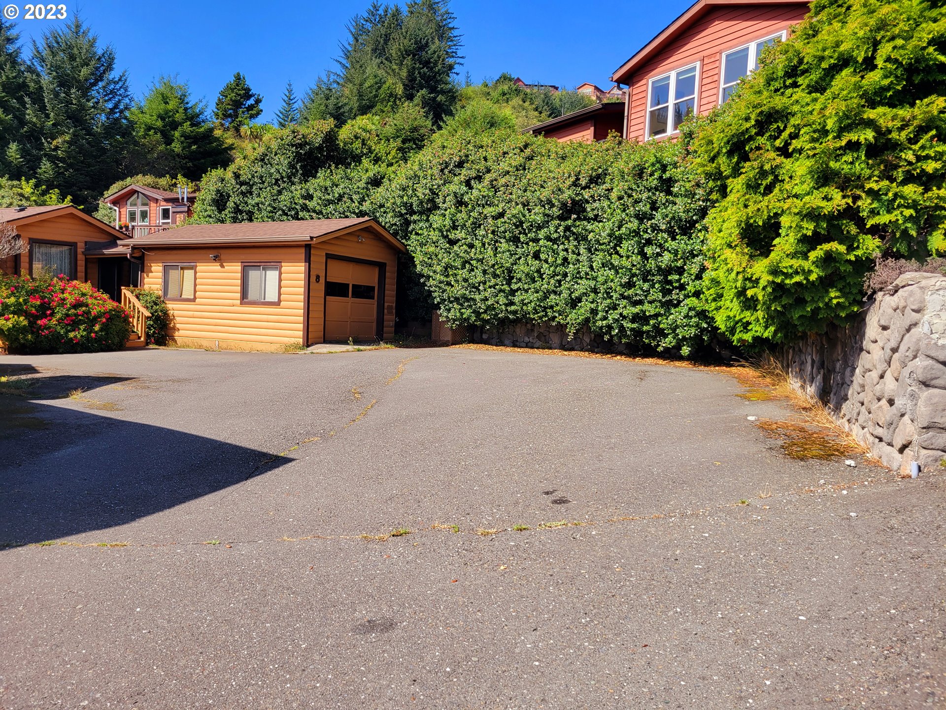 19921 Whaleshead Road, Unit OV8 Brookings, OR 97415 - Photo 47 of 48 a front view of a house with a yard and garage