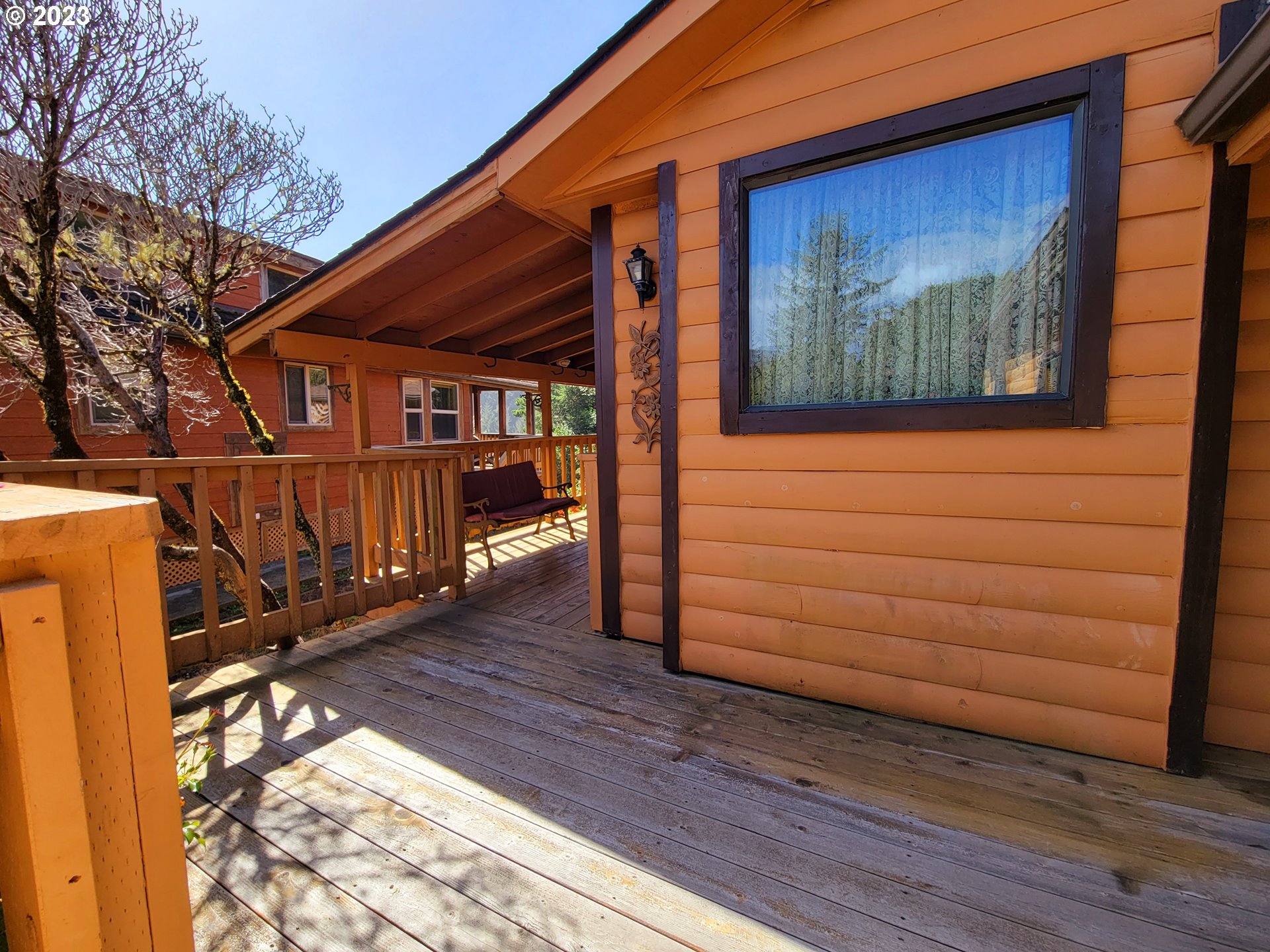 19921 Whaleshead Road, Unit OV8 Brookings, OR 97415 - Photo 9 of 48 a view of a house with a wooden fence
