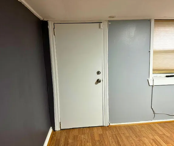 a view of a room with wooden floor