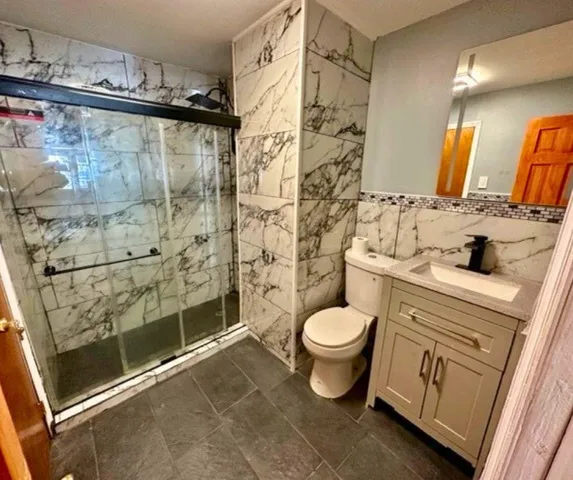a bathroom with a sink toilet and shower