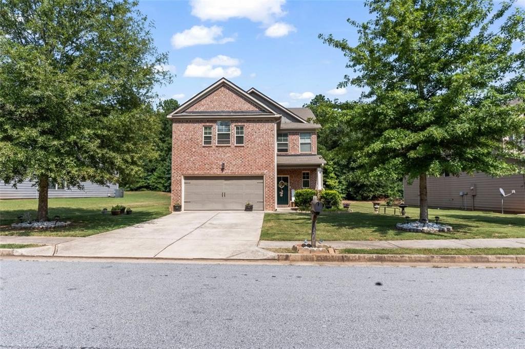 a front view of a house with a yard and garage