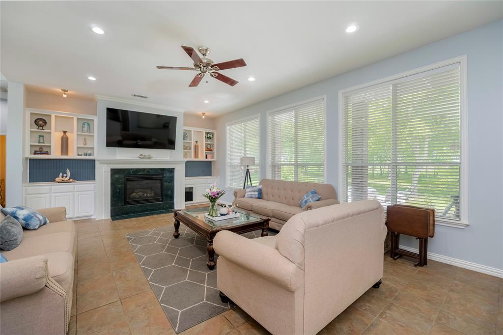 135 Kirkpatrick Road Ennis, TX 75119 - Photo 11 of 40 a living room with furniture fireplace and a flat screen tv
