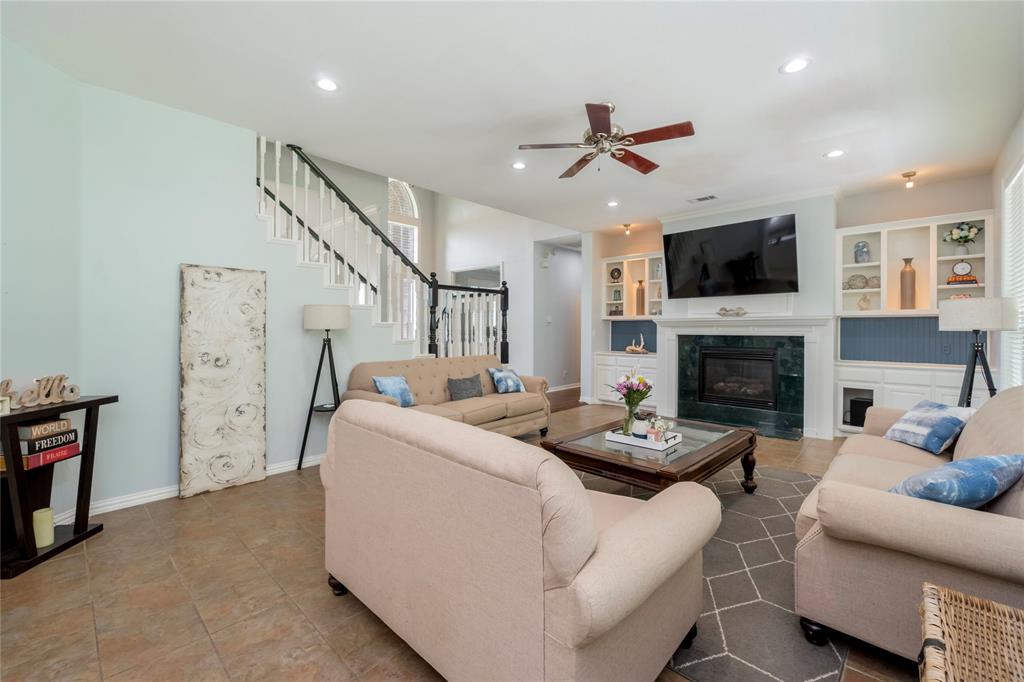135 Kirkpatrick Road Ennis, TX 75119 - Photo 12 of 40 a living room with furniture a flat screen tv and a fireplace