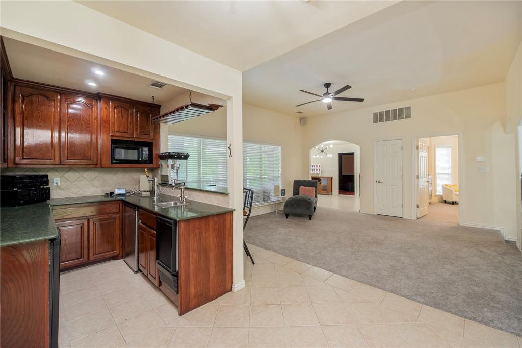 135 Kirkpatrick Road Ennis, TX 75119 - Photo 22 of 40 a large kitchen with stainless steel appliances granite countertop a stove and cabinets