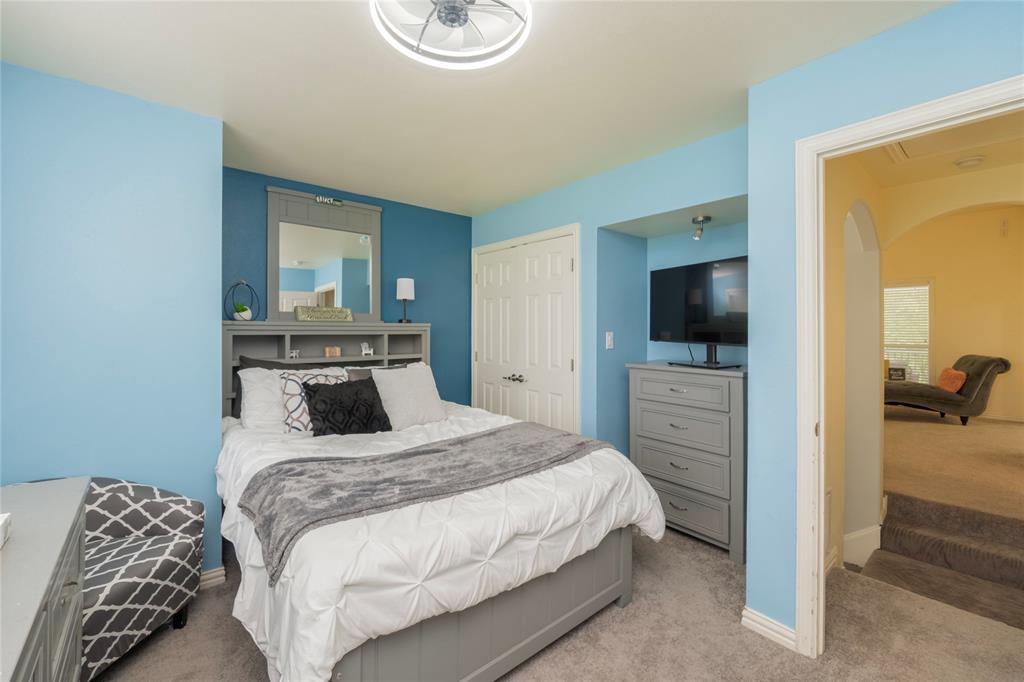 135 Kirkpatrick Road Ennis, TX 75119 - Photo 27 of 40 a bedroom with a bed and a flat screen tv