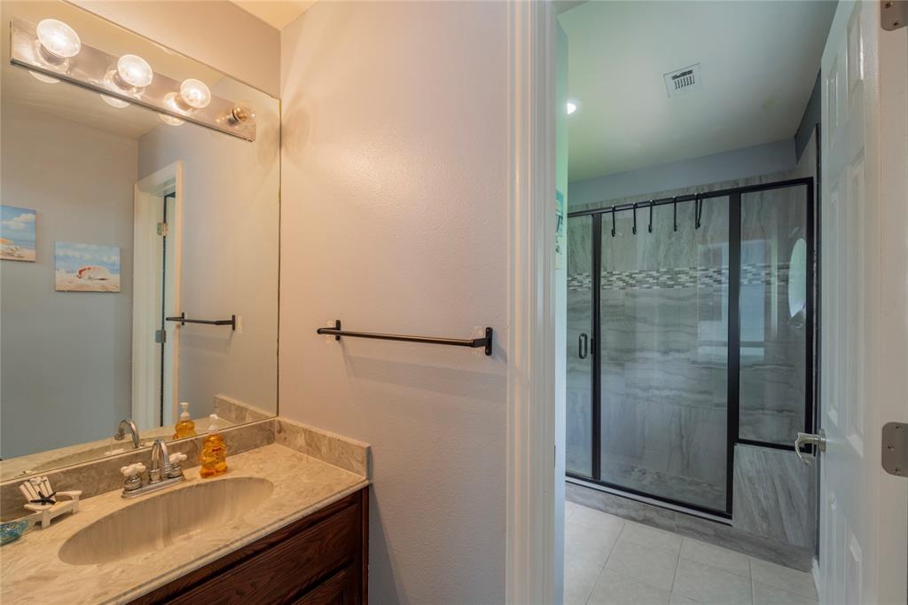 135 Kirkpatrick Road Ennis, TX 75119 - Photo 28 of 40 a bathroom with a sink mirror and shower
