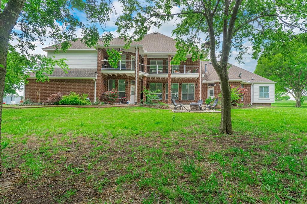 135 Kirkpatrick Road Ennis, TX 75119 - Photo 33 of 40 a view of a house with a yard and a large tree