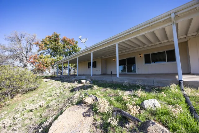 a view of house with yard