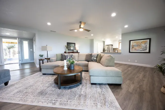 a living room with furniture and a chandelier