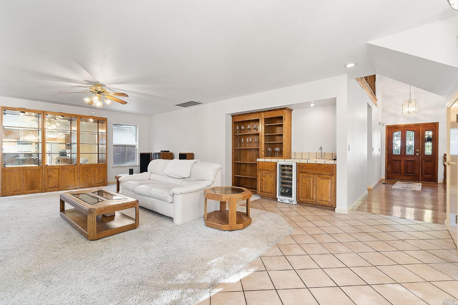 3525 Fieldcrest Avenue Fairfield, CA 94534 - Photo 12 of 31 a living room with furniture a flat screen tv and a floor to ceiling window