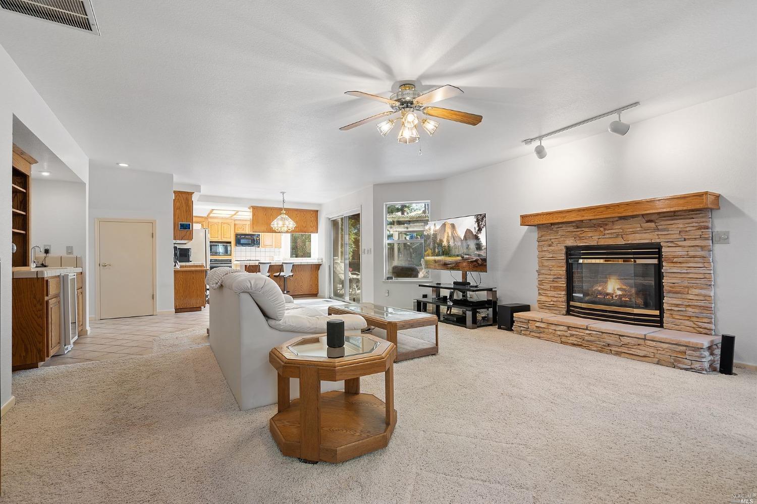 3525 Fieldcrest Avenue Fairfield, CA 94534 - Photo 13 of 31 a living room with furniture a fireplace and a flat screen tv