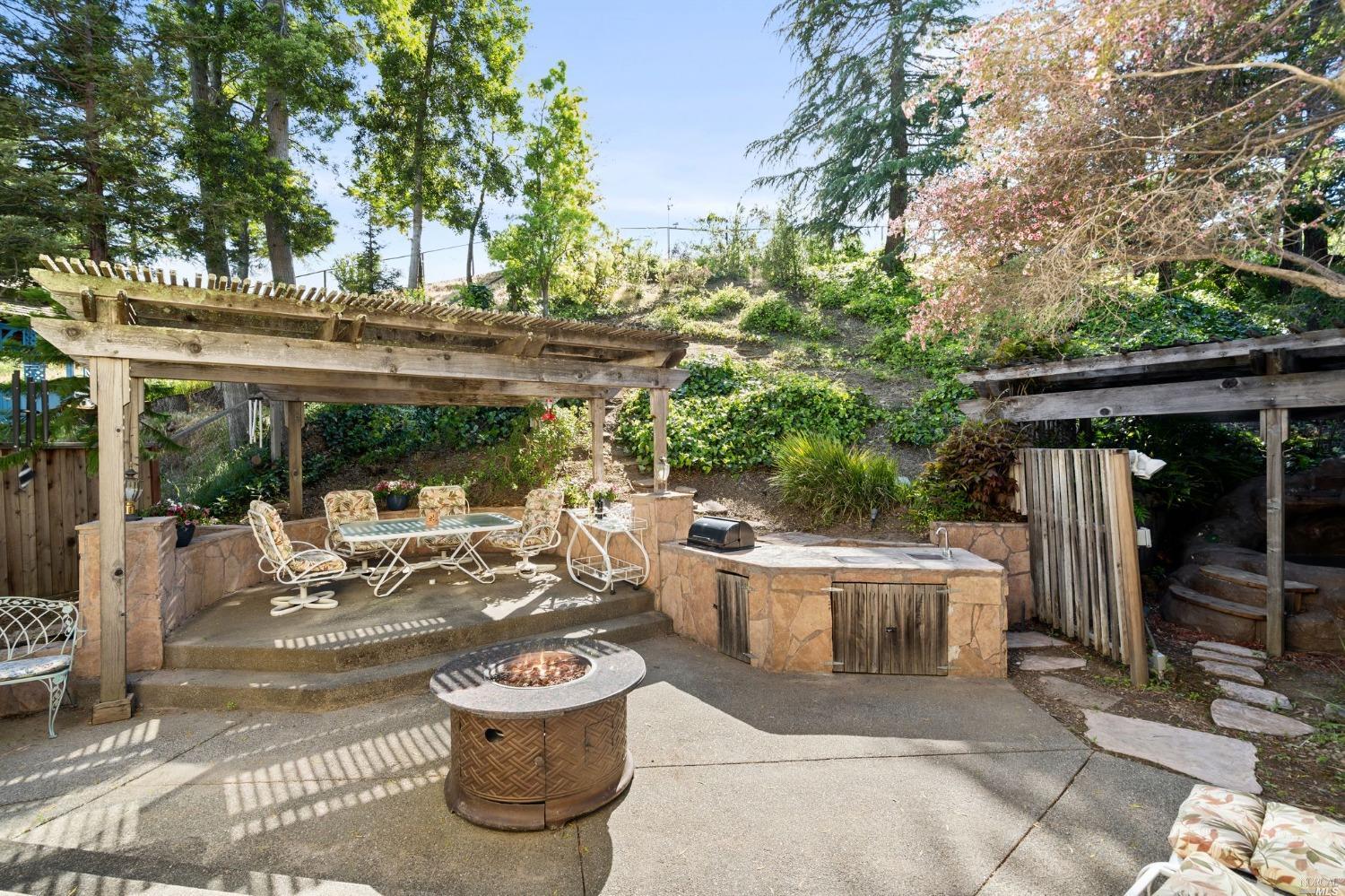 3525 Fieldcrest Avenue Fairfield, CA 94534 - Photo 15 of 31 a view of a patio with table and chairs potted plants and large tree