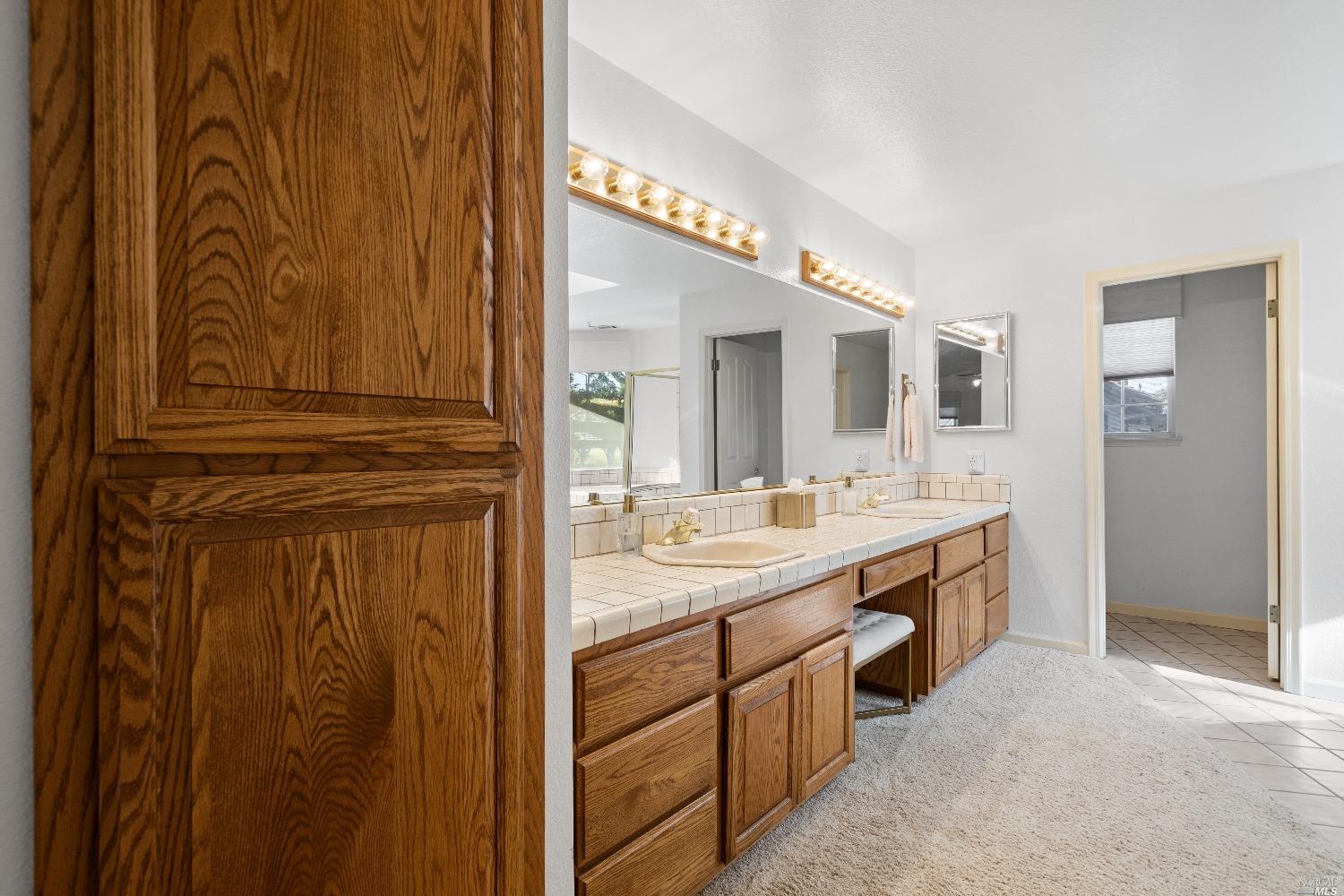 3525 Fieldcrest Avenue Fairfield, CA 94534 - Photo 22 of 31 a bathroom with a sink a mirror and a shower