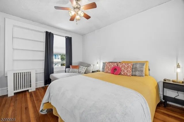 a kitchen with a stove and wooden floor