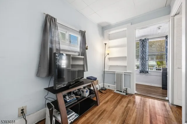 a living room with furniture and a ceiling fan