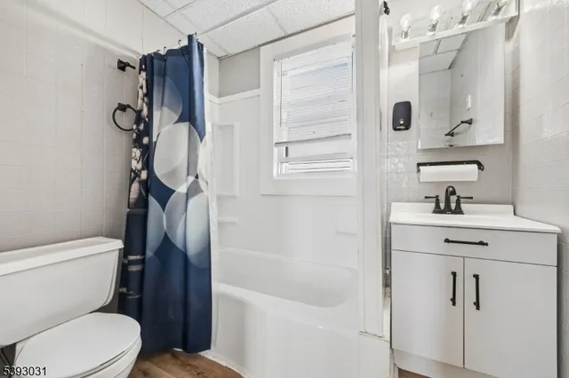 a kitchen with stainless steel appliances a stove a sink and white cabinets