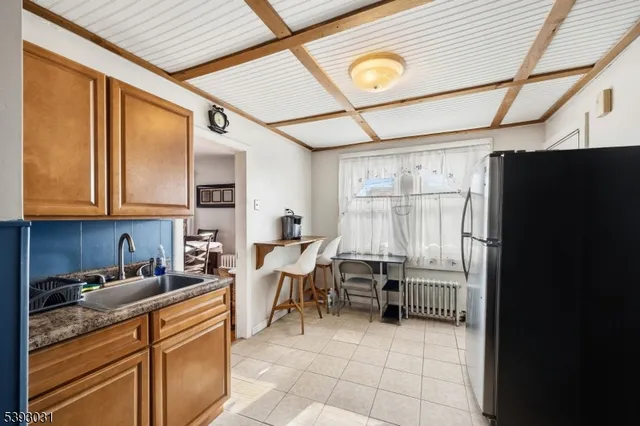 a kitchen with stainless steel appliances granite countertop a refrigerator and a stove