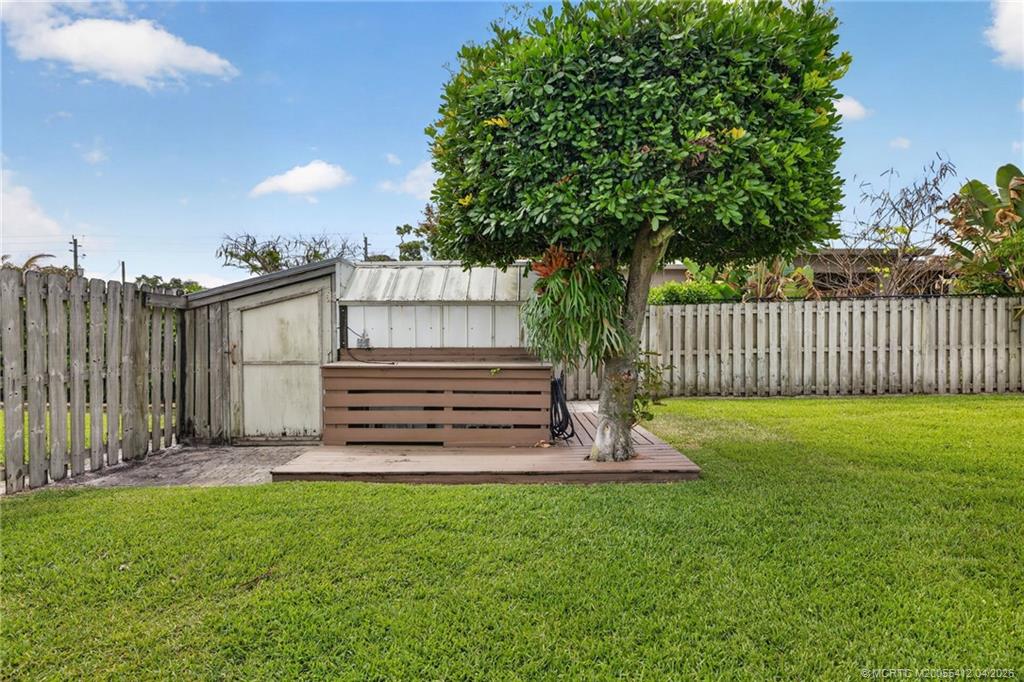 4844 Southeast Pilot Way Stuart, FL 34997 - Photo 15 of 50 a view of a backyard with wooden fence and a bench