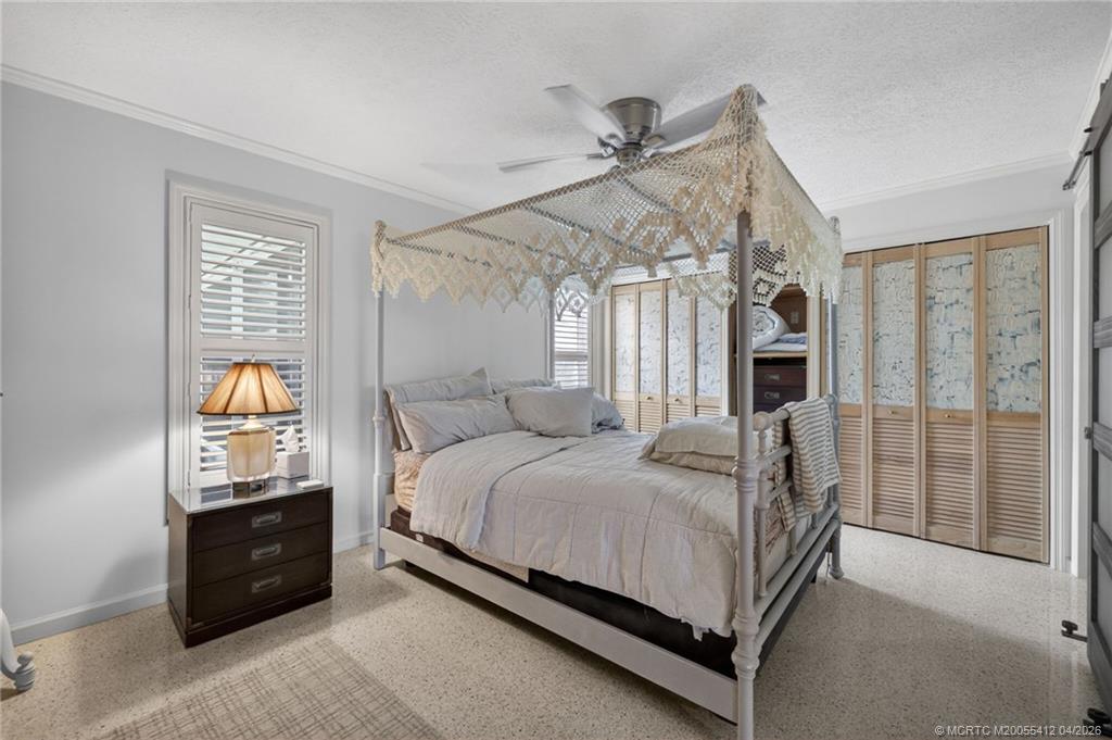4844 Southeast Pilot Way Stuart, FL 34997 - Photo 20 of 50 a bed sitting in a spacious bedroom next to a window