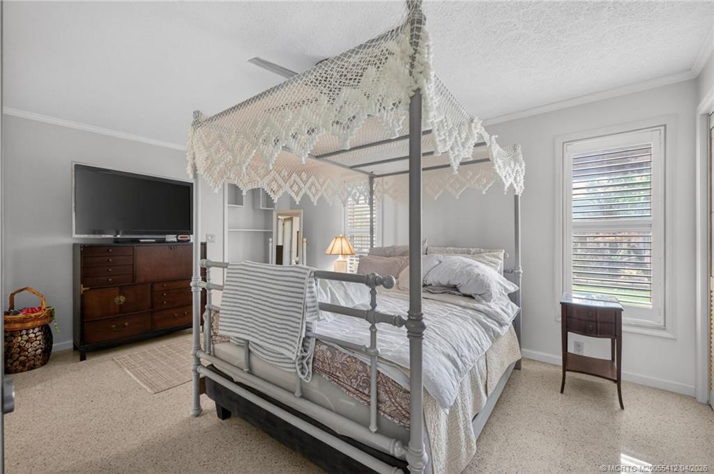 4844 Southeast Pilot Way Stuart, FL 34997 - Photo 21 of 50 a bedroom with furniture and a flat screen tv