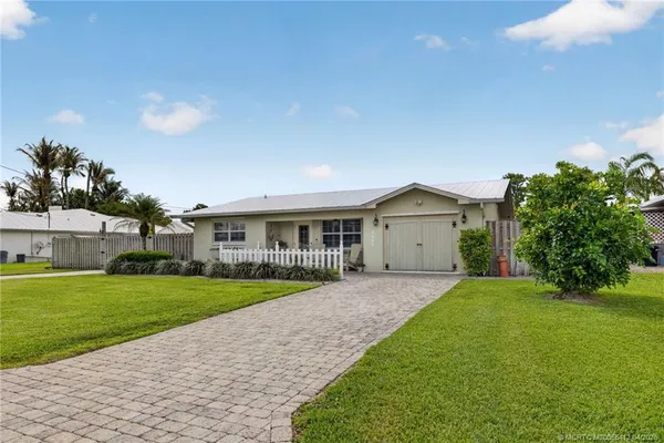 a view of a house with a backyard porch and sitting area