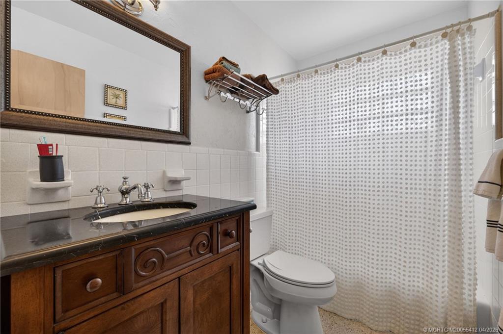 4844 Southeast Pilot Way Stuart, FL 34997 - Photo 44 of 50 a bathroom with a sink a toilet and mirror
