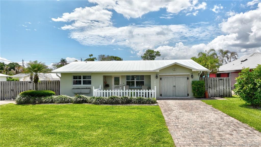 4844 Southeast Pilot Way Stuart, FL 34997 - Photo 46 of 50 a front view of a house with a garden