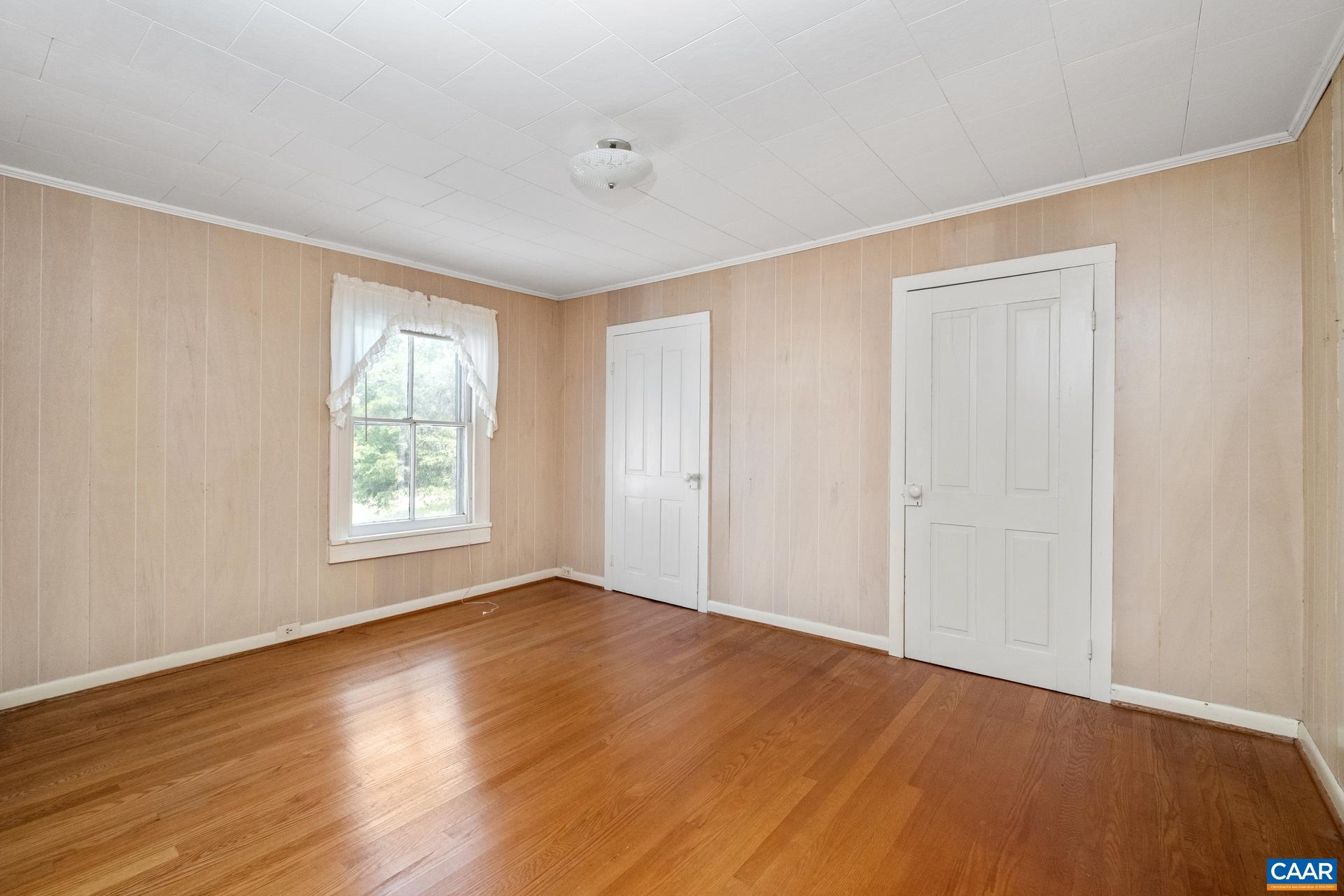 165 Shiloh Loop Faber, VA 22938 - Photo 28 of 33 a view of an empty room with wooden floor and a window