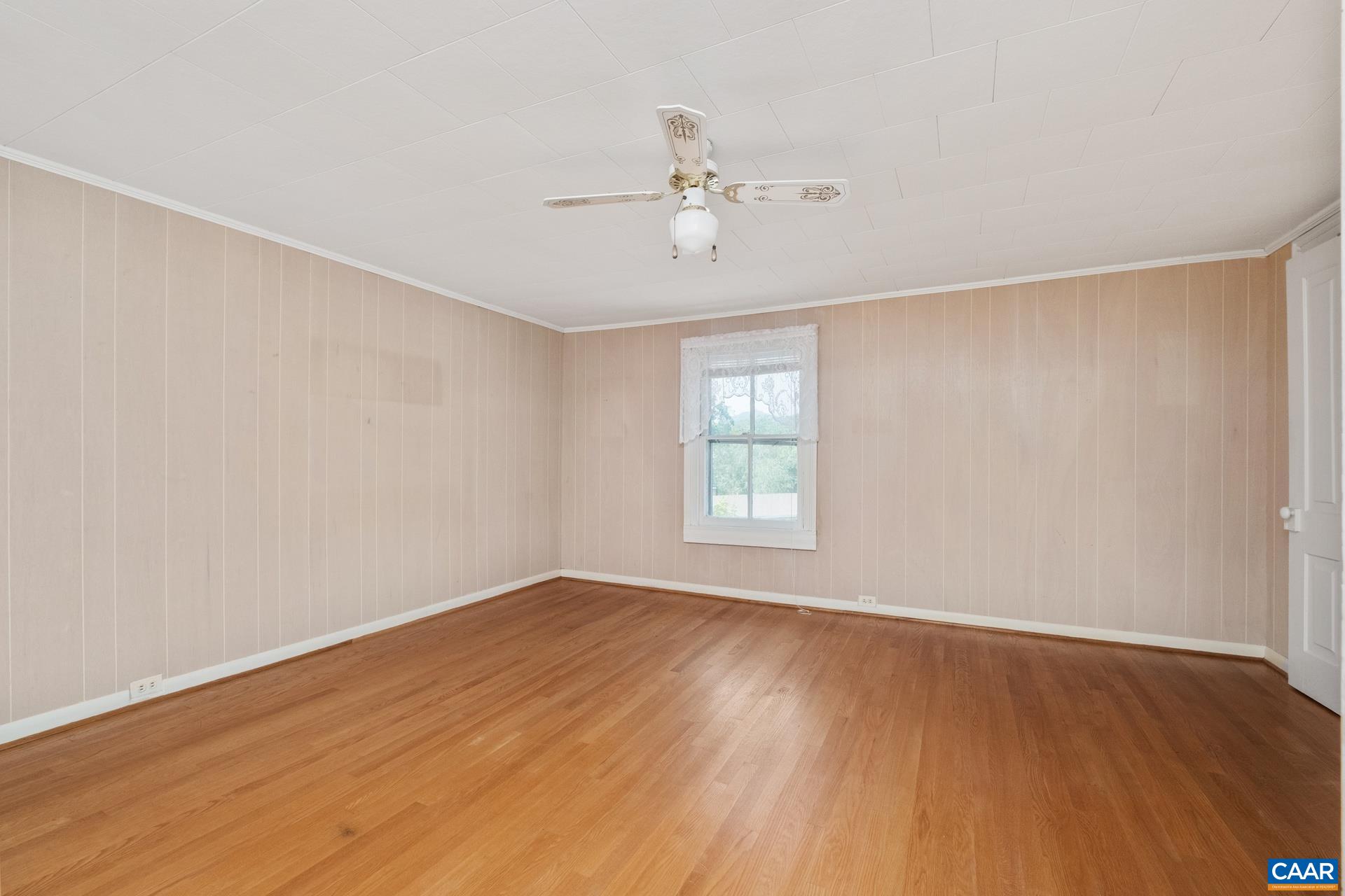 165 Shiloh Loop Faber, VA 22938 - Photo 31 of 33 an empty room with wooden floor fan and windows