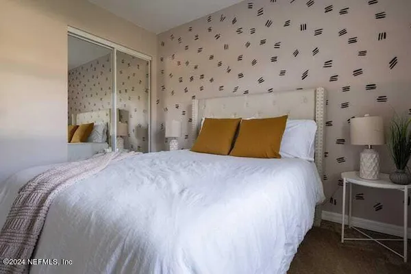 a bedroom with a bed and a night stand