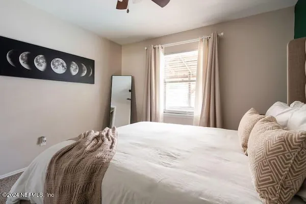 a bedroom with a bed and a window