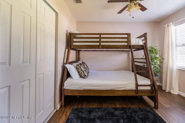 a bedroom with a bed and a potted plant