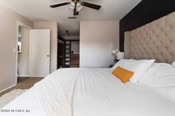 a bedroom with a bed and a night stand