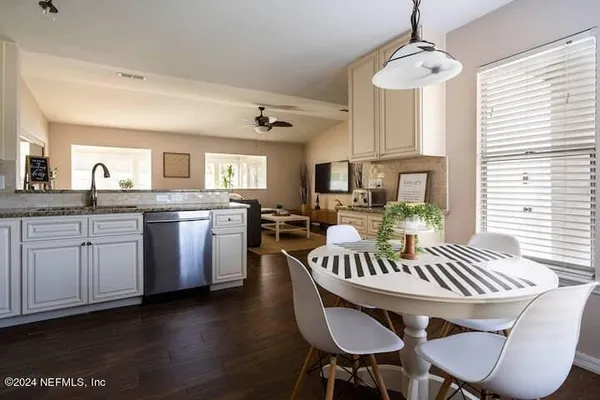 a view of a dining room with furniture window and wooden floor