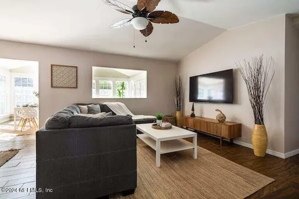 a living room with furniture and a flat screen tv