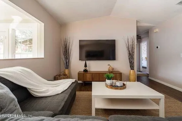 a living room with furniture and a flat screen tv