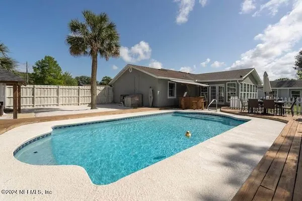 a view of a swimming pool with a patio