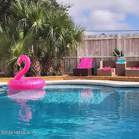 a view of swimming pool with a table and chairs