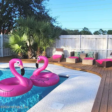a view of swimming pool with a table and chairs