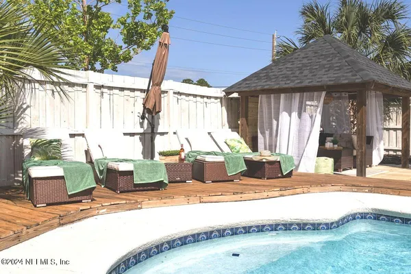 a view of a backyard with sitting area